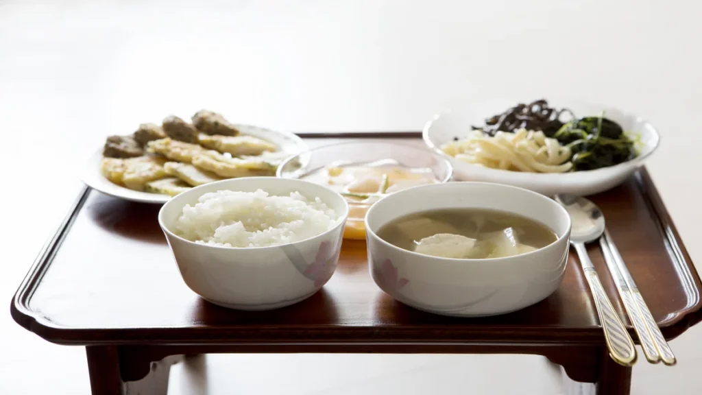 Traditional Korean table dining setting with metal chopsticks and spoons